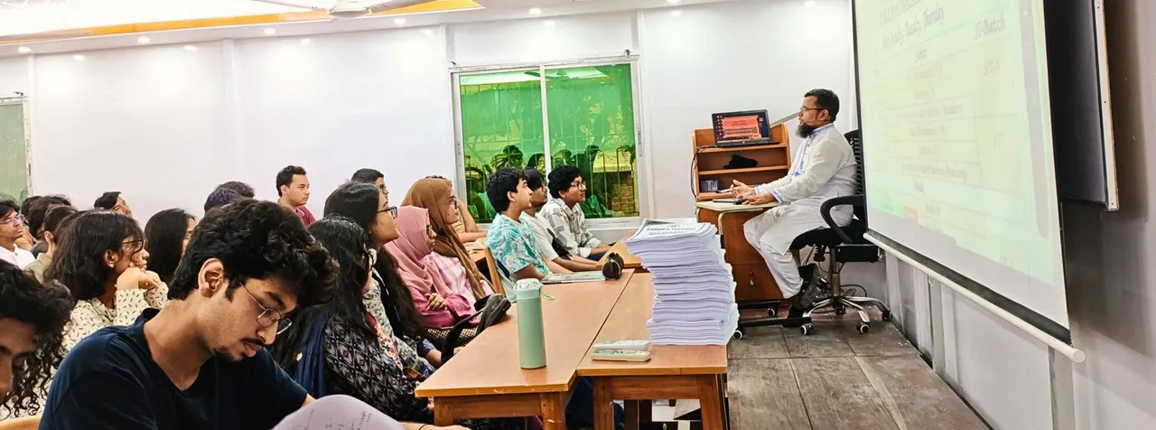 Samim Sir teaching a full class, with the lesson projected on a screen